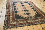 Distressed antique Malayer rug border, faded red, ivory geometric patterns, lost selvage.