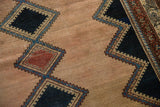 Distressed antique Malayer rug's geometric diamond pattern in dark navy and faded red.