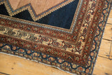Antique Distressed Malayer rug corner, intricate faded borders, and dark navy field.