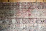 Detail of significant wear, exposed foundation, and knot heads on an antique Kerman carpet.