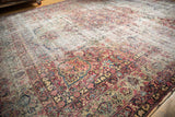 Dilmaghani Kerman trefoil medallion and scrolling florals in cochineal red, navy, ivory, displaying extensive wear.
