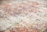 Threadbare pile and exposed foundation showing faded floral arabesques on an antique Kerman rug.