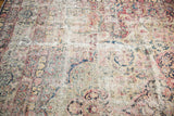 Severe pile wear and visible foundation on an antique Kerman floral rug.