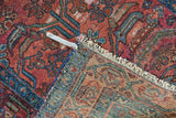 Vintage Lilihan runner corner, revealing allover plant motif, worn pile, fringe, and woven reverse.