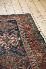 Original looped fringe and geometric border on a vintage Karaja rug, showing terracotta and navy stylization.