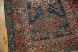 Visible knot head wear and geometric patterns on vintage Karaja rug side.