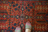 Diminutive central medallion with delicate vines and weeping willow motifs in raspberry and navy.