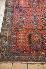 Hand-knotted vintage Bibikabad rug corner, with raspberry red field and weeping willow motif.
