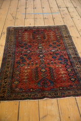 Bibikabad rug's secured fringe and ornate navy blue and raspberry red border.
