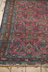 Vintage Lilihan rug's tattered end, with even pile wear and detailed blue-brown border.