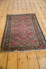 Vintage Lilihan rug end with tattered fringe, showing wear and multi-color border.