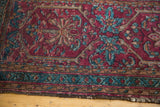 Vintage Lilihan rug's traditional raspberry red and sapphire blue meandering vine border, worn edge.