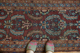 Vintage Heriz runner detail: European-influenced Herati design, aubergine red, low pile showing foundation.