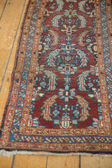 Angled view of Heriz runner's end, showing low pile, secured side, and delicate fringe.