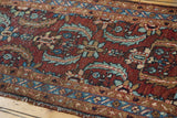 Vintage Heriz runner with low pile and aubergine red Herati motifs, showing tattered end.
