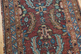 Heriz runner with Herati stylized motif, aubergine red, powder blue, low pile, and faint foundation.