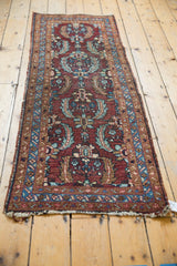 Tattered fringe on vintage Heriz runner end, showing low pile, Herati motif in aubergine, blue.