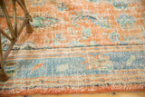 Textural close-up of distressed vintage Oushak carpet with rusty tangerine and sky blue.