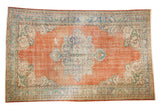 Distressed Oushak rug with scalloped medallion, tangerine orange field, dusty blue, and ivory. 5'6