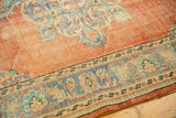 Distressed vintage Oushak rug showing visible wear to knot heads, tangerine orange, and detailed dusty blue border.