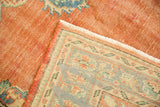 Vintage Oushak carpet's secured edge, clean fringe, and textured woven foundation.