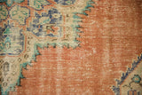 Distressed texture and serrated design in dusty tangerine, teal, royal blue.