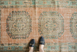 Distressed Oushak runner featuring pale blush field and mint rams horn latch medallions.