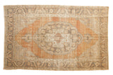 Distressed vintage Oushak rug with apricot medallion, Rococo details, charcoal border, 5'2