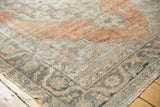 Distressed vintage Oushak carpet with worn pile, showing faded apricot and charcoal.
