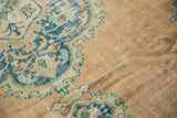 Distressed vintage Oushak rug pile with faint foundation through sandalwood, aqua, and mint contour.