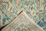 Faded aqua and beige distressed Oushak rug, dusty rose binding, and hand-knotted reverse.