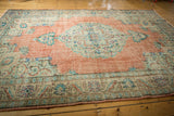 Distressed terracotta field with mint green lotus and vine Oushak border.