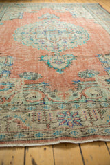 Vintage Distressed Oushak carpet, its worn texture featuring dusty rose terracotta and soft mint.
