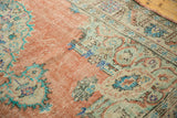 Distressed texture of a vintage Oushak rug with dusty rose and mint green Rococo contours.