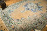 Vintage Distressed Oushak carpet corner spandrel, Rococo stylized, with mostly even wear.