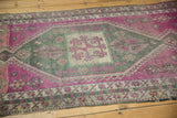 Textured pile with distressed purple, charcoal geometric pattern on vintage Oushak runner.