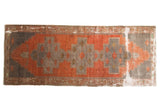 Distressed Oushak runner with triple geometric medallion and rectilinear vinery in red, silver, green.