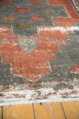 Distressed texture and geometric motifs in brick red and oxidized silver Oushak runner.