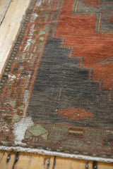 Distressed Oushak rug edge showing rectilinear patterns, madder red, silver, and foundation wear.