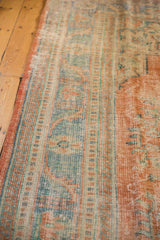 Textured distressed Oushak rug edge with even wear, featuring terracotta and ocean blue-green.