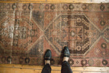 Vintage Oushak runner with distressed blush and charcoal tones and worn medallion details.