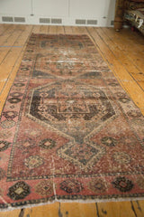 Distressed Oushak runner with worn blush, charcoal, and bronze medallion details.