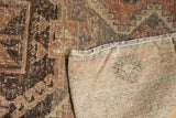 Distressed vintage Oushak rug runner showing hand-knotted foundation, secured fringe, and muted patterns.
