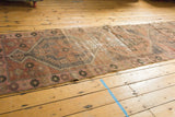 Close-up of distressed Vintage Oushak runner, showing heavy wear and muted blush, rose, charcoal hues.