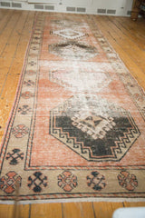 Distressed vintage Oushak runner: chocolate brown stepped medallion, pinwheel interior, pale terra cotta field.