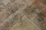 Distressed pile showing foundation and secured edge of vintage Oushak runner.