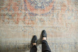 Distressed vintage Oushak carpet pile showing faded rose blush, antique ivory, and denim blue vinery.