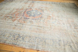 Distressed Oushak carpet texture with faded rose blush, ivory, and royal blue vinery.