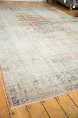Distressed vintage Oushak rug showing worn pile, rose blush border, and short fringe.
