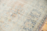 Distressed Oushak rug texture showing rose blush, antique ivory, and denim blue motifs.